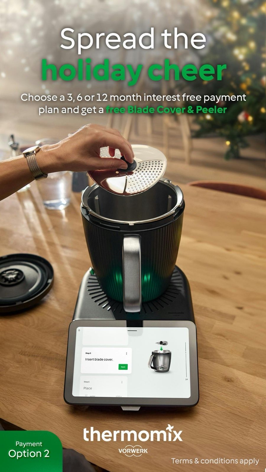 Thermomix TM7 jug with blade cover and tablet showing guided cooking steps